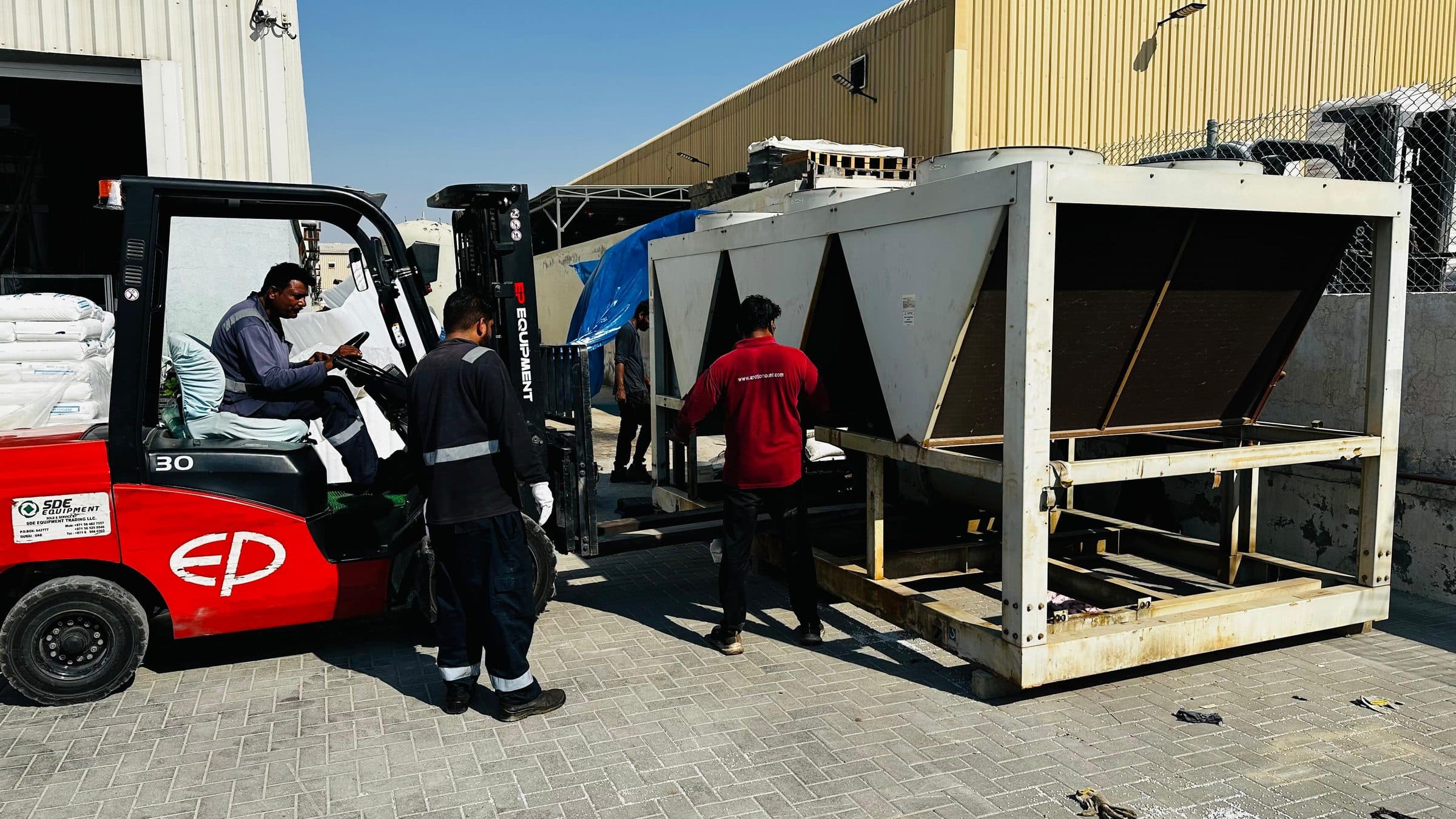 Forklift moving an air-cooled chiller at the Arctic Mount yard