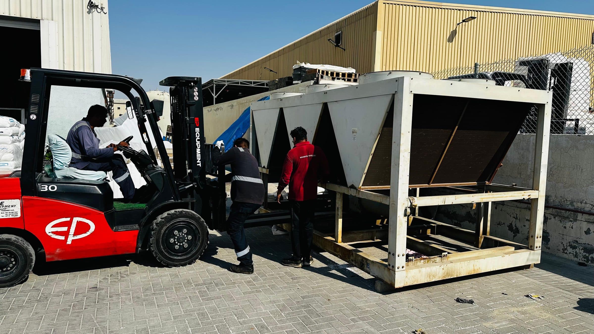 Air-cooled chiller being repositioned by forklift
