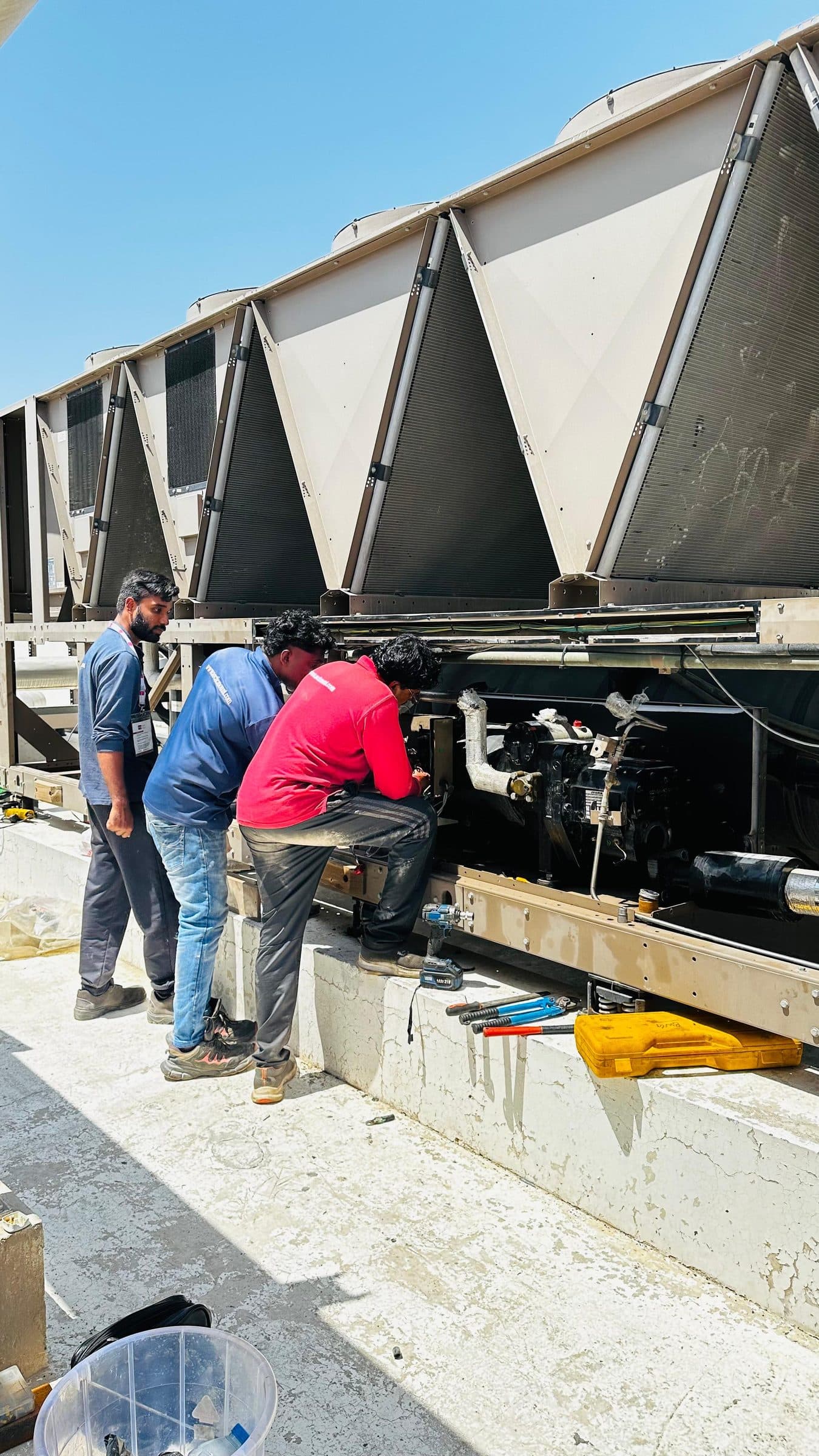 Technicians at the chiller compressor bay